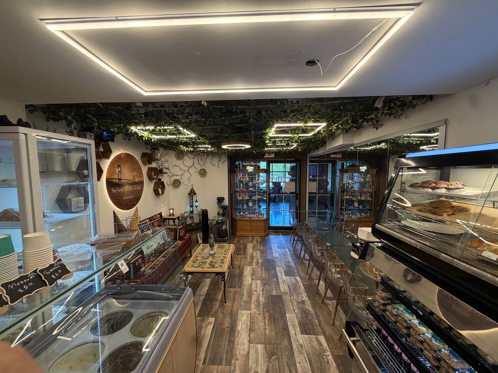 Cafe counter, pastry displays, and seating at Seven Hills Istanbul Cafe